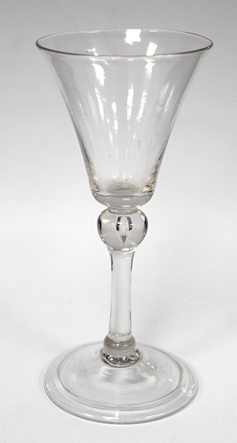 A balustroid wine glass, c.1740, with round funnel bowl, teared knop stem, folded foot, 17cm high. Condition - good